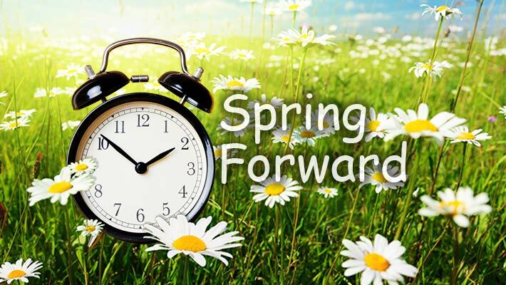 Daylight Savings Time. Clock in a field of flowers.